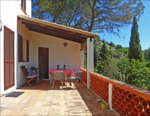 a patio of a house with a table and chairs at Mountain Finca with Pool in Puigpunyent