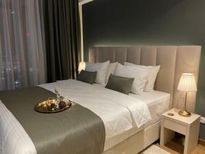 a bedroom with a large bed with a tray on it at BW Sky View Belgrade Waterfront in Belgrade