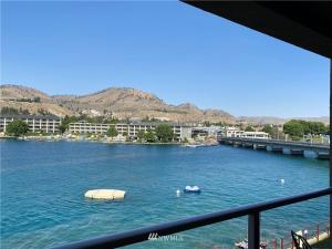 a view of a river with a boat in it at Grandview Lake Chelan- Waterfront View, Pool, Hot tub, Golf, 1 Min To Downtown in Chelan