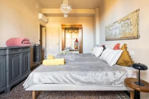 a bedroom with a large bed and a chandelier at La Didì Maison in Bologna +42 photos