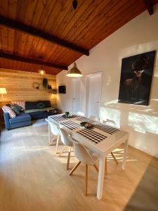 a living room with a white table and chairs at Forest Lodge in Petit Mesnil +34 photos