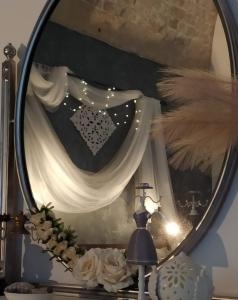 a mirror on a table with a heart on it at Casa vacanze San Giovanni nei Sassi in Matera