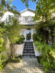 Cape Town的住宿－Constantiaberg Eco-Villa，白色的房子,有一条通往前门的小路