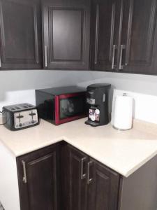 a kitchen counter with a coffee maker and a toaster at Brand New 2-Bedroom Basement Apartment with Free parking! in Brampton