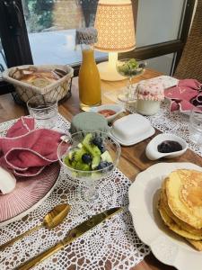 a table with plates of food on a table at B&B Temps Suspendu Provence in Pernes-les-Fontaines