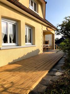 a wooden deck in front of a house at Les pierres de Lecq in Portbail