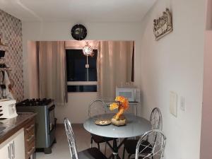 a kitchen with a table and chairs in a kitchen at Apartamento 2 - CARUARU-PE in Caruaru +9 photos