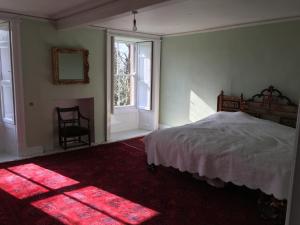 a bedroom with a bed and a window at Swinton Manse & Gardens in Swinton