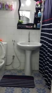 a bathroom with a sink and a toilet and a mirror at Chez Eva Jolie in Dakar +14 photos