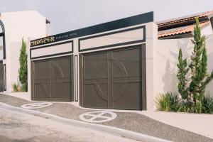 a rendering of two garage doors on a building at Prosper Executive Hotel in Capivari