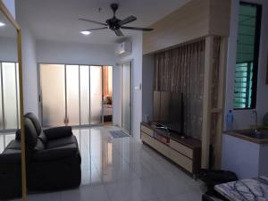 a living room with a couch and a flat screen tv at Era Amazing Manhattan Suite in Penampang