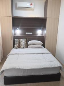 a bedroom with a large bed with a headboard at Era Amazing Manhattan Suite in Penampang