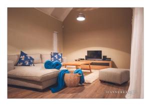 ein Wohnzimmer mit Sofa und Tisch in der Unterkunft Bruckendorf Self Catering Apartment in Swakopmund