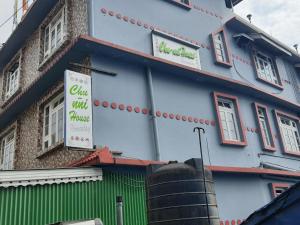 a building with a sign on the side of it at Chunni homestay in Gangtok
