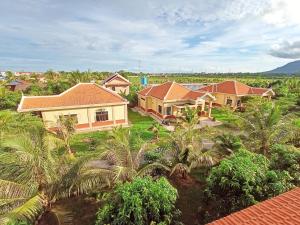 an aerial view of a house with palm trees at Karma Traders Kampot in Kampot