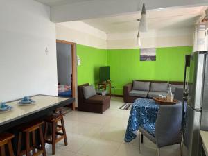 a kitchen and a living room with green walls at Green bay 2 in Pereybere