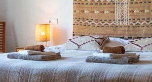 a bed with a blanket and pillows on top of it at Guesthouse Villa Altea in Altea