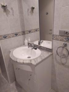 a bathroom with a white sink and a shower at Eucalytus I in Salou