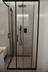 a shower with a glass door in a bathroom at Apartman PENNY in Zvolen