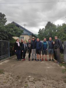 a group of people posing for a picture in front of a house at Kurjun in Karakol +24 photos