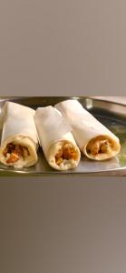 four burritos on a tray on a table at Royal residency in Tindummal +87 photos