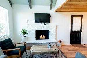 a living room with a fireplace with a flat screen tv at Tidal House #10 - Ocean Shores Chalet in Ocean Shores
