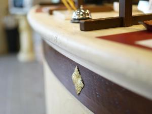 a hole in the side of a wooden counter with a drawer at Hotel AreaOne Takamatsu City in Takamatsu