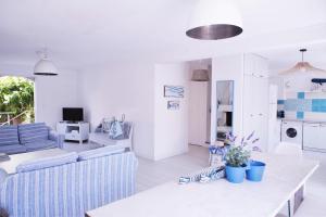 a living room with a couch and a table at Les galets bleus de Calvi in Calvi