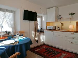 a kitchen with a table with a blue table cloth on it at Ferienwohnung Saunahaus in Annaberg im Lammertal