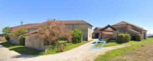 a dirt road next to a house with a playground at Le Gîte du haut in Châtillon-la-Palud