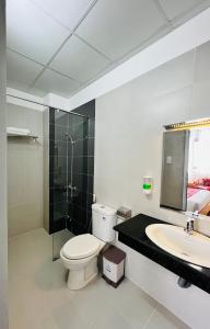a bathroom with a toilet and a sink and a shower at Dalat ECO Hotel 2 in Da Lat