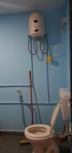 a bathroom with a toilet in a room at ORANGE SKY INN HOLIDAY HOME in Canacona