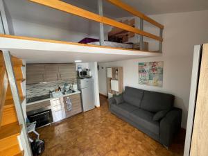 a living room with a couch and a kitchen at AirCon Los Cristianos, Quiet zone, Chipeque in Arona