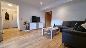 a living room with a couch and a table at Appartement Alpenblick in Gosau