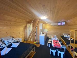 a bedroom with a bed and a desk and a staircase at Etno selo Kaćo in Sjenica