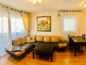 a living room with a couch and a table at Royal Apartments , Blvd Nitza 8 in Netanya