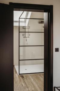 a glass door leading into a room with a chandelier at Gavershof in Geraardsbergen