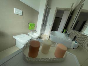 a bathroom with a sink and a toilet at Sunrise Residence in Santa Domenica