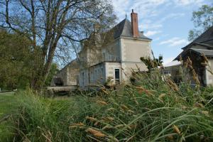 an old house with a tower on top of it at Chambre d'hôte Moulin de l'Aumonier in Beaulieu-lès-Loches