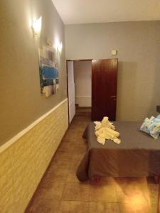 a hotel room with two beds and a door at departamento del centro in La Falda