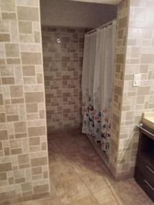 a bathroom with a shower with a shower curtain at departamento del centro in La Falda