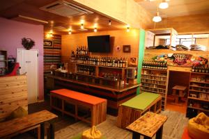a bar in a restaurant with a counter and benches at みーまん奄美 in Amami
