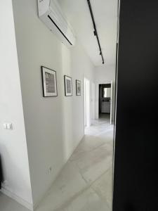 a hallway with white walls and a stair case at Apartament 8015 in Jelenia Góra