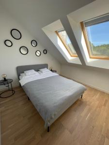 a bedroom with a large bed in a room with skylights at Apartament 8015 in Jelenia Góra