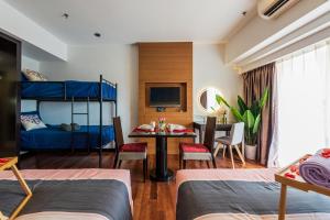 a bedroom with a bunk bed and a dining room at Lagoon View 6pax Homestay at Sunway Resort Suites in Petaling Jaya