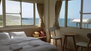 a bedroom with a bed and a view of the ocean at Lover's Bay in Magong