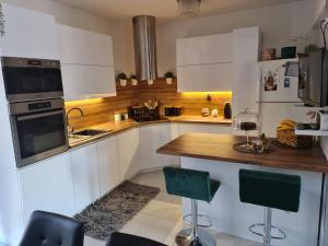 a kitchen with white cabinets and a wooden counter top at Luxury Apartments Mia in Podstrana