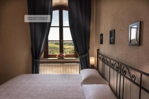מיטה או מיטות בחדר ב-Il Torrino
