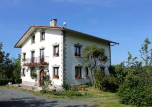 a white house on the side of a road at Olaskoaga Goikoa in Aia