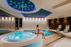 a woman sitting in a hot tub in a hotel at Hotel Du Lac in Limone sul Garda